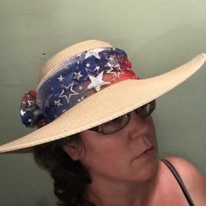 Wide brimmed floppy woven hat w/tied scarf